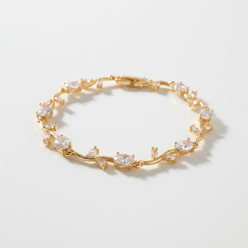Gold bracelet with floral design on a white background