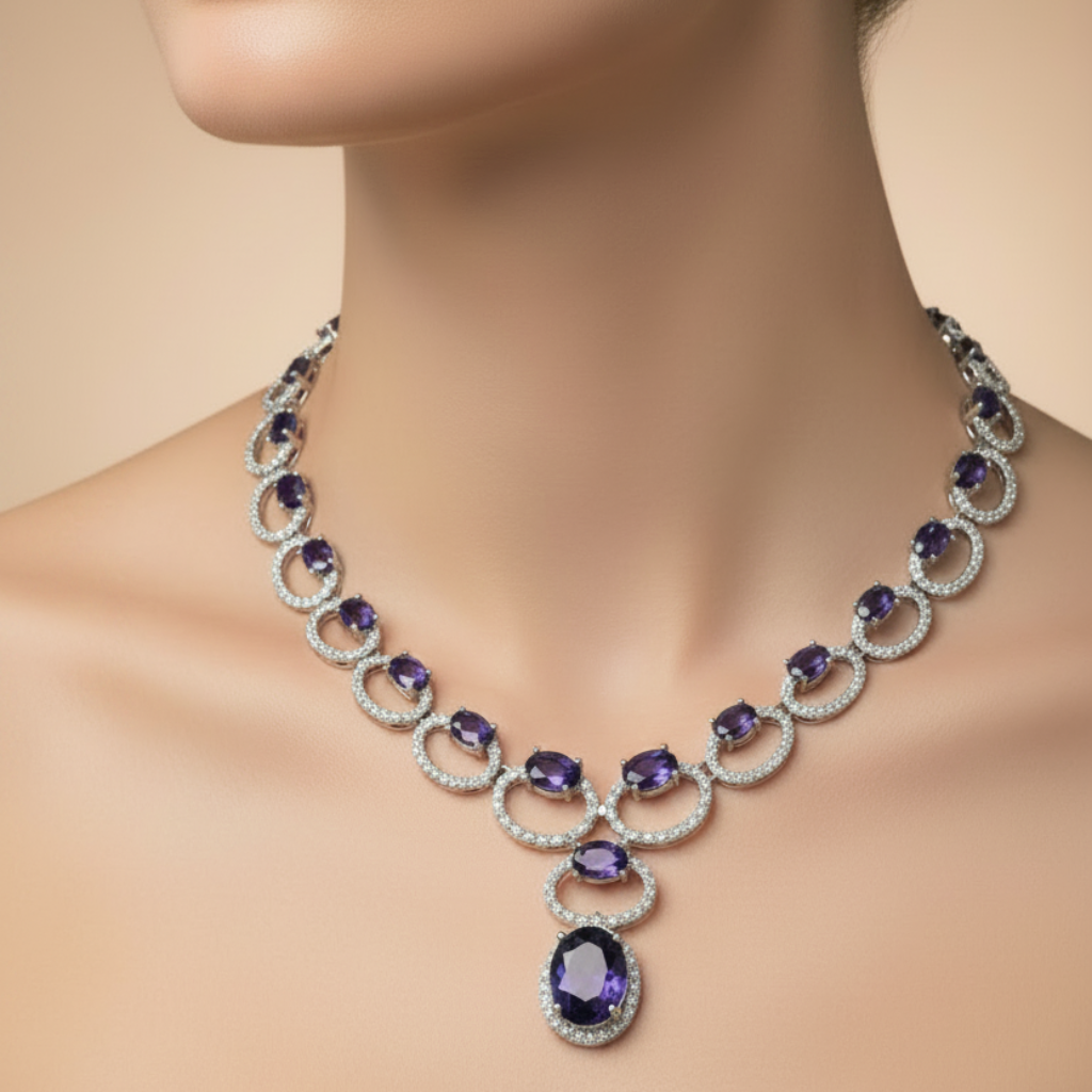 Jewelry set with necklace and earrings featuring purple gemstones on a neutral background